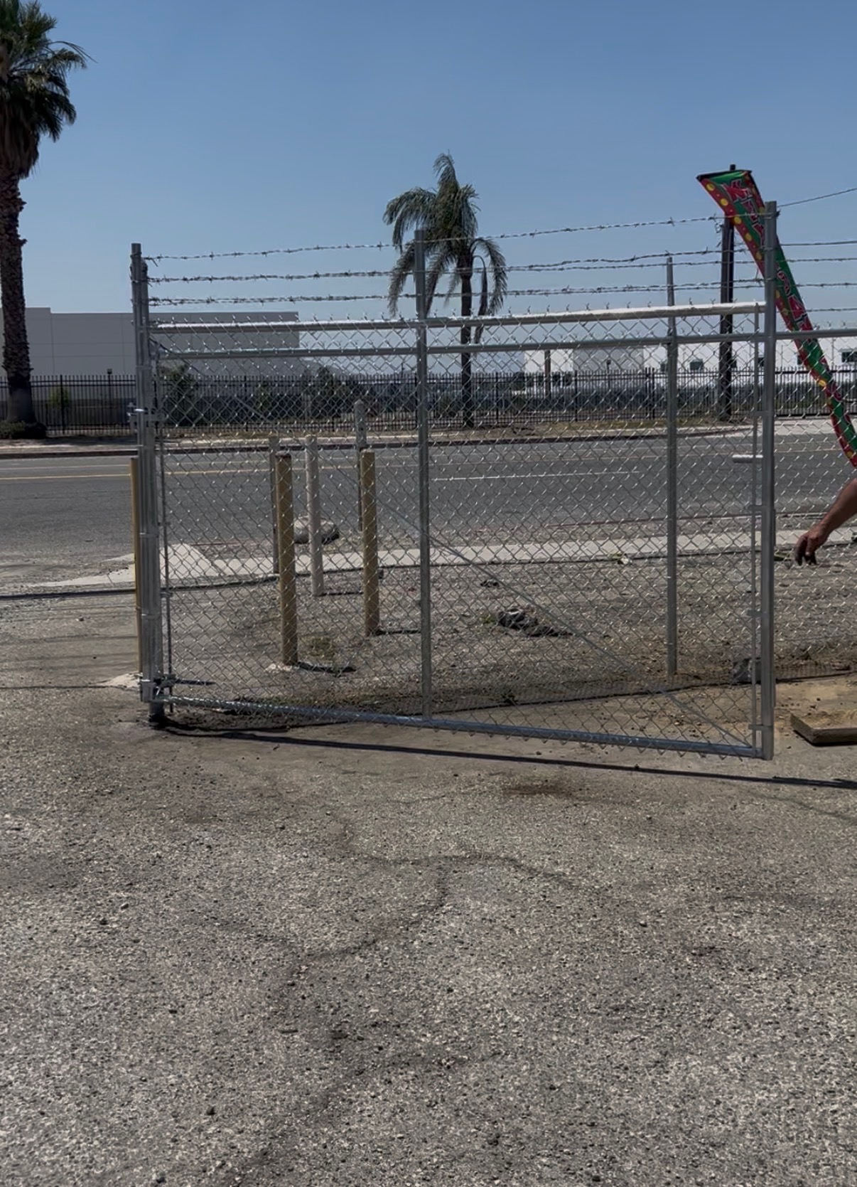 Commercial chain link rolling gate with barbed wire