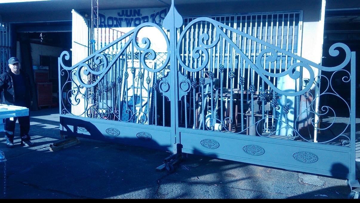 Custom fabricated double iron driveway gate with scrollwork